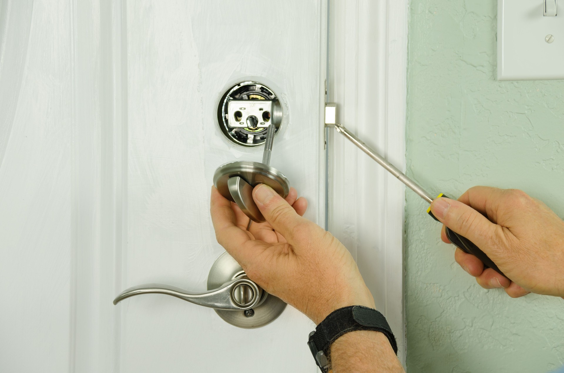 Repairing installing door deadbolt lock on house closeup